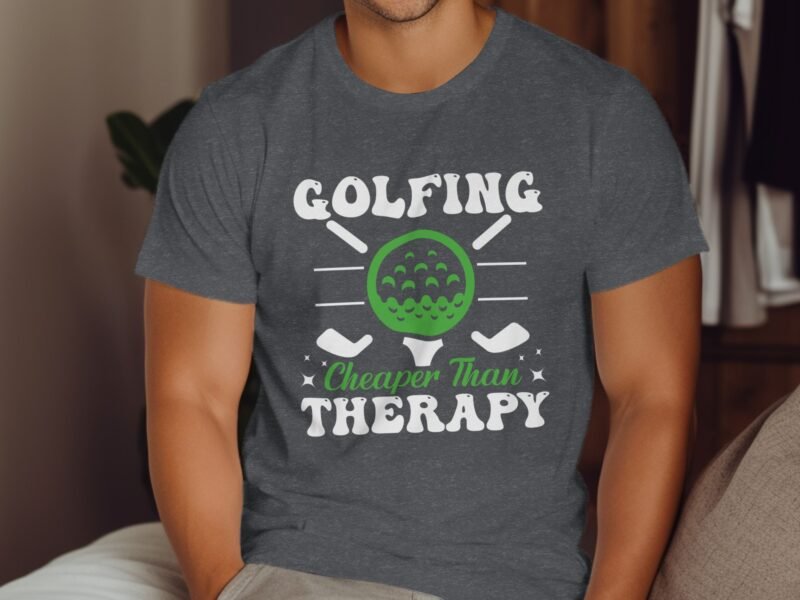 Man wearing a gray t-shirt with "Golfing Cheaper Than Therapy" printed, featuring a green golf ball graphic.