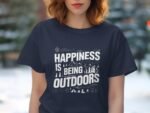 A person with wavy hair wears a navy blue t-shirt featuring the text "Happiness is Being Outdoors" and outdoor icons.