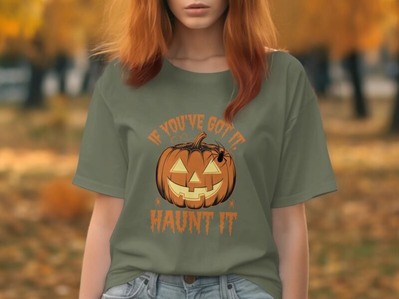 A woman in a green T-shirt features a pumpkin graphic with the text "IF YOU'VE GOT IT, HAUNT IT," set against an autumn backdrop.