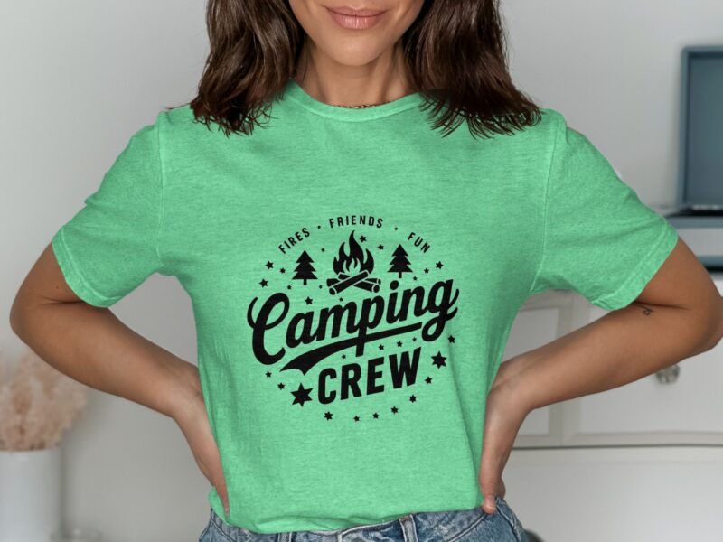 Person wearing a green t-shirt with "Camping Crew" graphic, featuring trees and a campfire design.