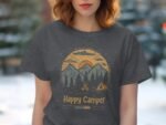 A woman wears a gray t-shirt featuring a "Happy Camper" graphic with mountains, trees, and a campfire design.