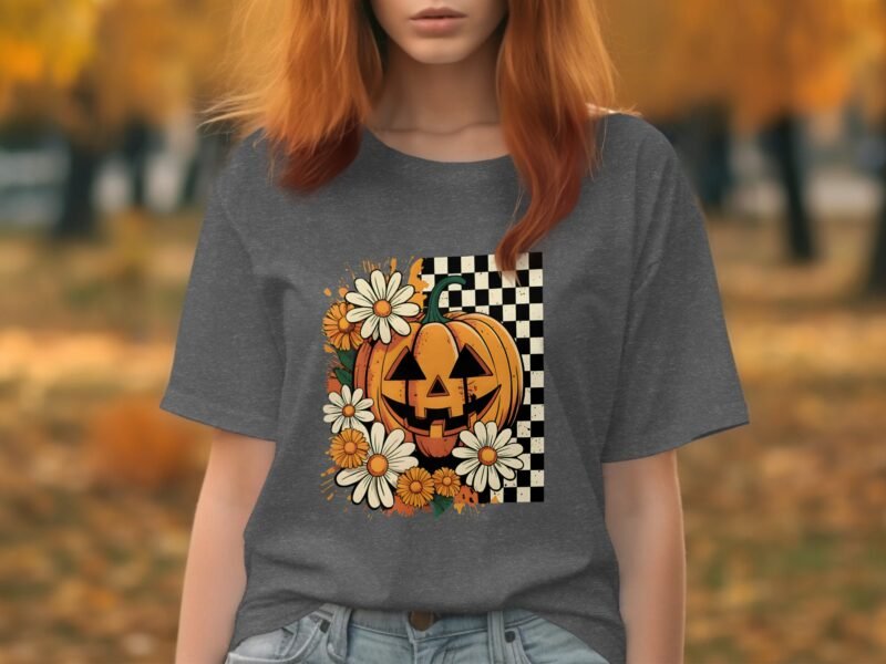 A woman wears a gray t-shirt featuring a pumpkin and daisies on a black and white checkered background.