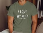 Man wearing an olive green t-shirt with the text "I LOVE it WHEN MY WIFE LETS ME GO FISHING" displayed prominently.