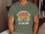 A man in a green t-shirt with a golf-themed graphic and the text "MY RETIREMENT PLAN IS GOLFING" displayed prominently.