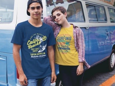 a man and woman standing along side a camper van